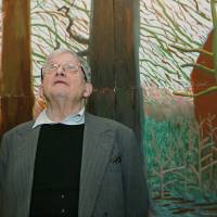 Definitive?: David Hockney stands in front of his painting \"Bigger Trees Near Warter,\" a work whose inclusion in a new art survey is questioned by the reviewer. | BLOOMBERG