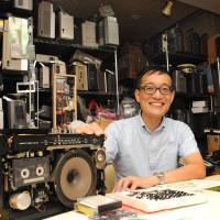 Electronic wiz: Junichi Matsuzaki shows one of 3,000 boomboxes he has collected and stocks at his studio in Adachi Ward, Tokyo. Rescuing gadgets from the golden age of 'Made in Japan'