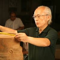 Heritage: Tadahiro Ogawa, seen at work in museums in Nagano Prefecture believes really good photos of Jomon artifacts can greatly help today\'s Japanese connect with their forebears. | EDAN CORKILL