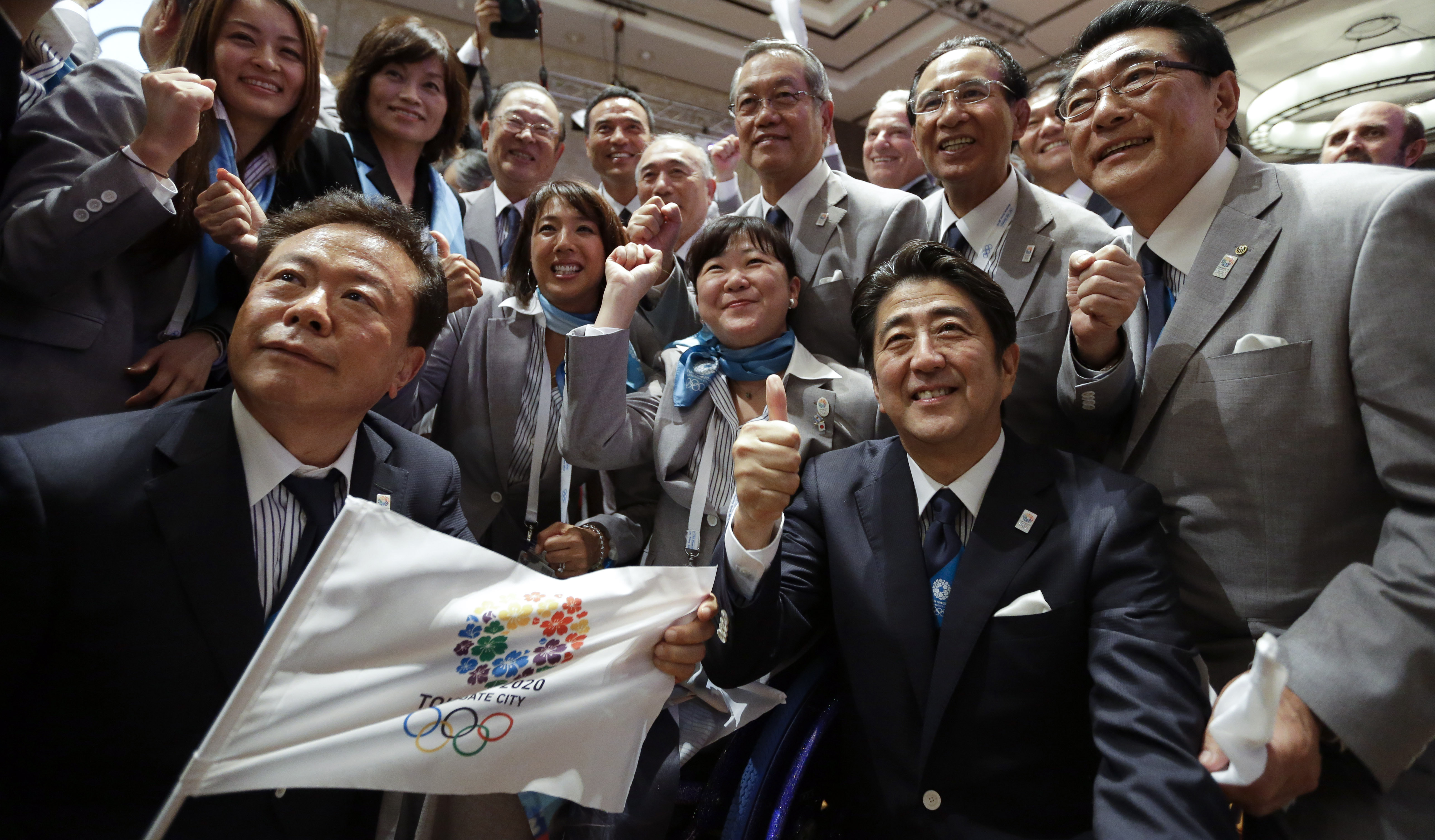 Pass the pork, cue the crackdown: Prime Minister Shinzo Abe (thumbs up), Tokyo Gov. Naoki Inose (left) and members of the capital's Olympic delegation celebrate the city's selection as host of the 2020 Olympic Games, in Buenos Aires on Sept. 7. | AP