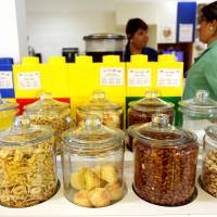 Brain food: Employees talk near snack jars in one of microkitchens in Google\'s New York office. Google co-founder Sergey Brin insists that every employee be no more than 60 meters away from free food. The idea is that food brings people together, and new products and services could be imagined when workers meet in kitchens and dining halls. | YANA PASKOVA / THE WASHINGTON POST