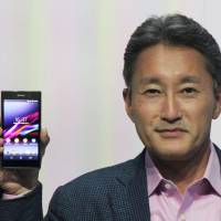 Hold the phone: Sony Corp. Chief Executive Officer Kazuo Hirai holds the company\'s new Xperia Z1 smartphone, featuring an improved lens to boost camera performance, at a press event in Berlin on Wednesday. | KYODO
