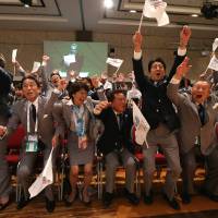 Prime Minister Shinzo Abe (third from right) celebrates alongside Tokyo 2020 delegation members as IOC president Jacques Rogge announces the Japanese capital as the winner of the bid to host the 2020 Summer Olympic Games, during the 125th session of the International Olympic Committee, in Buenos Aires on Sept. 7. | AFP-JIJI