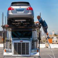 Locked and loaded: A Nissan Rogue is loaded onto a car carrier at the Port of Los Angeles for dealer delivery on June 28. Nissan said Tuesday it has revamped the popular SUV to get a bigger share of the growing crossover segment. | BLOOMBERG
