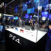 First look: People gather around a model of Sony\'s new PlayStation 4 console at Tokyo Game Show in Chiba on Thursday. | YOSHIAKI MIURA