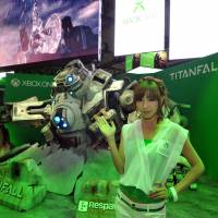 A model shows off the \"Titanfall\" display at Microsoft\'s Xbox One booth. | YOSHIAKI MIURA