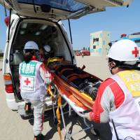 State of readiness: A \"survivor\" is placed in an ambulance during a joint disaster response drill held in Chiba on Sunday on the anniversary of the 1923 Great Kanto Earthquake. | AFP-JIJI