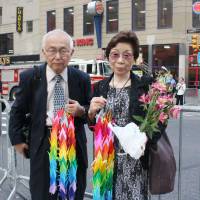 Remembering: Kazusada and Mari Sumiyama, who lost their son Yoichi Sugiyama in the Sept. 11, 2001, attacks on the United States, is seen near the former site of the World Trade Center in New York on Wednesday. | KYODO