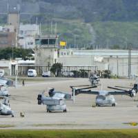 On the flight line: MV-22 Osprey tilt-rotator aircraft sit on the tarmac at U.S. Marine Air Station Futenma in Ginowan, Okinawa Prefecture, last month. | KYODO