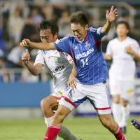 Easy does it: Yokohama F. Marinos forward Manabu Saito (right) takes on the Vanraure Hachinohe defense during his side\'s 5-1 Emperor\'s Cup second-round win on Wednesday. | KYODO