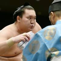 Job well done: Hakuho exhales after winning his bout on Saturday. | KYODO