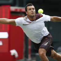 That’s a stretch: Jo-Wilfried Tsonga reaches for a ball during his first-round match against fellow Frenchman Gael Monfils at the Japan Open on Monday. Tsonga won 6-3, 7-6 (10-8). Tsonga beats Monfils to make triumphant start at Japan Open