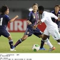 Hold steady: Japan\'s Yoko Tanaka (left) and Homare Sawa (center) defend during Sunday night\'s 2-0 friendly win over Nigeria. | KYODO