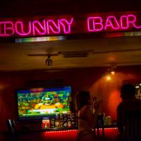A customer sits with an employee inside the brothel\'s bar area on Aug. 20. | BLOOMBERG