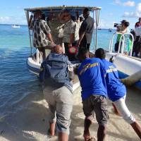 Trouble in paradise: Pacific Island Forum leaders leave Eneko Island en route to the Marshall Island\'s capital of Majuro on Sept. 5. That day, the Pacific island nations adopted the \"Majuro declaration,\" which sets out ambitious climate targets. | AFP-JIJI