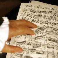 Complex: A wax figure of Johann Sebastian Bach rests its hand on sheet music for a violin sonata at Madame Tussauds in Berlin in July 2008. | BLOOMBERG