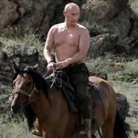 Siberian summer: Current Russian President Vladimir Putin rides a horse during a vacation outside the southern Siberian town of Kyzyl in August 2009, when he was prime minister. | AFP-JIJI