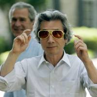 Bright future: Then-Prime Minister Junichiro Koizumi puts on Elvis-style shades after being taken on a tour of Graceland, the Memphis, Tennessee, home of Elvis Presley, by U.S. President George W. Bush in 2006. | AP
