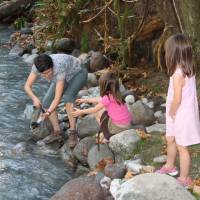 Wonderworld: Kate Keogh (above), vice principal of North Vancouver Outdoor School near Squamish, British Columbia, shows my twin granddaughters a male pink salmon she caught with her bare hands in a spawning channel of the Cheakamus River. | C.W. NICOL PHOTO