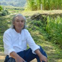 In harmony: \"Weird farmer\" Yutaka Une at ease on his land in Itoshima, Fukuoka Prefecture. | WINIFRED BIRD