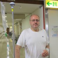 \"Every month is a struggle\":  Two days after learning he had cancer,  Tokyo-based English teacher Neil Grainger was told he was HIV-positive. Months later, his employer,  Waseda University International Corp., said it would not renew his contract. In the end, Grainger was offered a six-month contract that expired at the end of September. He is now jobless. | SIMON SCOTT