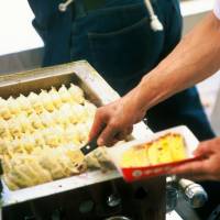 Cheap and tasty: Gy&#333;za are served at Utsunomiya\'s annual dumpling festival. | ASAKUSA KANKORENMEI