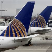 Awaiting push-back: United Airlines jetliners sit at Los Angeles International Airport on July 24. | BLOOMBERG