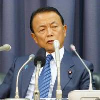 Tax advocate: Finance Minister Taro Aso speaks to reporters at the ministry on Tuesday. | KYODO