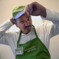 Still working: Tom Palome, a 77-year-old former vice president of marketing for Oral-B, adjusts his Sam’s Club cap at the AARP office in Tampa, Florida, on Sept. 5. He has two part-time jobs: one as a $10-an-hour food demonstrator at Sam’s Club, the other flipping burgers and serving drinks at a golf club grill for slightly more than minimum wage. At 77, he flips burgers to earn his old hourly wage in a week