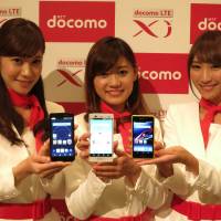 Fresh faces: Models pose with new NTT Docomo smartphones in Tokyo on Thursday. | KAZUAKI NAGATA