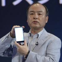 Clash of the titans: Masayoshi Son, chairman and CEO of SoftBank Corp., introduces the Aquos Xx302SH smartphone in Tokyo on Sept. 30. Straitjacket Japan could use more brawling billionaires to lead the way