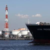 Staking their claim: A tanker carrying liquefied petroleum gas sails past an oil refinery in an industrial section of Kawasaki in September 2012. | BLOOMBERG