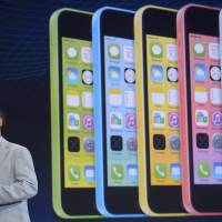 Outsize ambition: Masayoshi Son, chairman and CEO of Softbank Corp., speaks during a smartphone launch on Sept. 30 in Tokyo. Softbank said Tuesday it was purchasing a majority stake in Finnish game company Supercell, and was also in talks to buy U.S. mobile distributor Brightstart Corp. on Wednesday. | AFP-JIJI