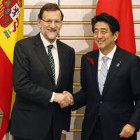 Amigos: Spanish Prime Minister Mariano Rajoy is greeted by Prime Minister Shinzo Abe prior to their Thursday meeting in Tokyo during the Madrid leader\'s three-day official visit to Japan. | POOL