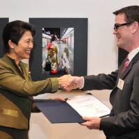 Picturesque: Princess Hisako awards the Prince Takamado Memorial Prize to Ciaran Chestnutt of the Australian Embassy during the opening of the \"Japan Through Diplomats\' Eyes\" photo exhibition at Roppongi Hills in Tokyo on Thursday. | YOSHIAKI MIURA