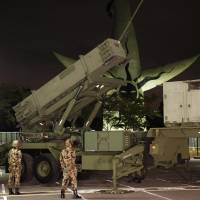 Lock and load: A Patriot anti-missile battery is set up by the Air Self-Defense Force in Expo Park in Suita, Osaka Prefecture, during a drill Wednesday night. | KYODO