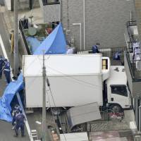 Assault with a deadly weapon: Police inspect a house rammed by a man\'s truck Thursday in Kawaguchi, Saitama Prefecture. | KYODO