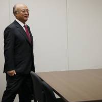 Hard scrutiny looms: Yukiya Amano (left), director general of the International Atomic Energy Agency, is greeted by Nuclear Regulation Authority Chairman Shunichi Tanaka in Tokyo on Thursday. The visiting Amano urged the government to work harder to address international fears about toxic water gushing from the Fukushima No. 1 nuclear complex, and said the U.N. watchdog will jointly monitor radiation levels in the Pacific. | AP