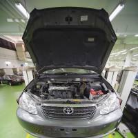 Up on the rack: A mechanic repairs a Toyota at a dealership in Singapore. A U.S. jury Friday ordered the automaker to pay $3 million in damages over the fatal crash of a defective Camry. Toyota fined $3 million by U.S. jury