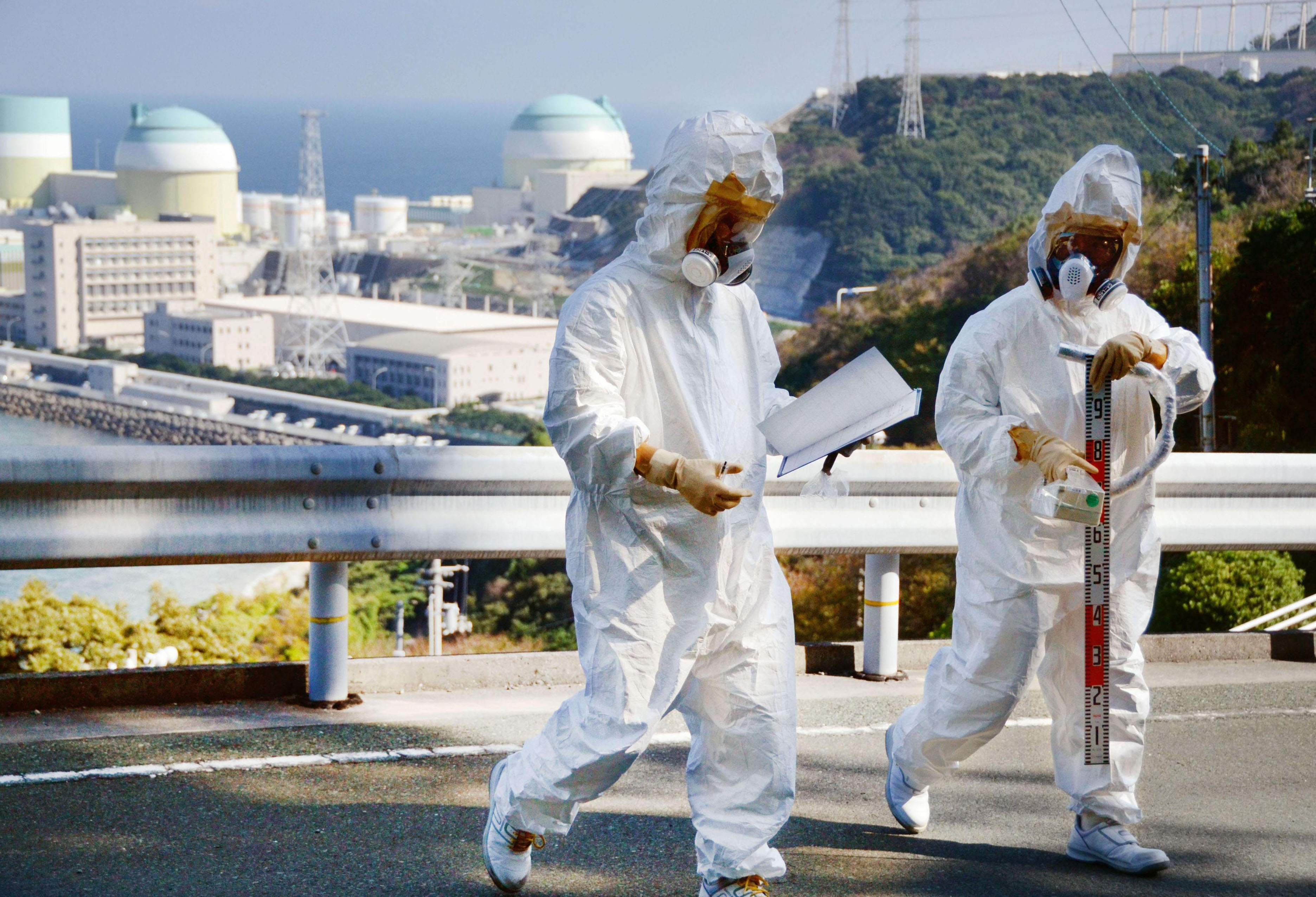Basic training: Workers measure the level of radioactive substances around Shikoku Electric Power Co.'s Ikata atomic plant in Ehime Prefecture during a nuclear crisis drill Tuesday | KYODO