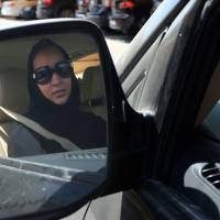 Taking the wheel: Saudi activist Manal al-Sharif, who now lives in Dubai, drives her car in the city Tuesday during a campaign for Saudi women\'s rights | AFP-JIJI