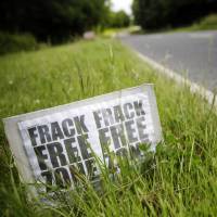 Drilling it in: An anti-fracking protest sign stands on the side of a road leading to Cuadrilla Resources Ltd.’s exploratory shale gas drilling site in Balcombe, England, in July. 'Frack off': U.K. energy debate erupts