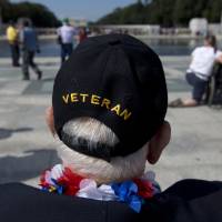 Temporary victory: World War II Veteran George Bloss, from Gulfport, Mississippi, looks out over the National World War II Memorial in Washington on Tuesday. Veterans who had traveled from across the country were allowed to visit the memorial after it had been officially closed because of the partial government shutdown. After their visit, National World War II Memorial was closed again. | AP