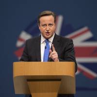 Going back to his roots: British Prime Minister David Cameron addresses delegates at the Conservative Party\'s annual conference in Manchester on Wednesday. | BLOOMBERG