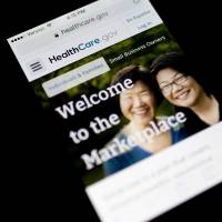 Teething troubles: The Healthcare.gov website is displayed on a phone in Washington on Thursday. | BLOOMBERG