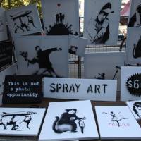 Original signed works by secretive British graffiti artist Banksy are sold at a stall in New  York\'s Central Park on Saturday. According to the artist\'s website, eight people over the course of the day were seen buying the works for just &#36;60 apiece. The works of Banksy, who refuses to give his real name, typically sell for thousands of dollars. banksy.co.uk | BLOOMBERG