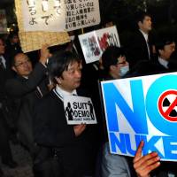 Hot biz: Protesters hold signs against atomic power during the anti-nuclear demonstration Suit Demo on Wednesday evening in Tokyo. | SATOKO KAWASAKI