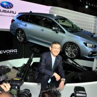 Subaru President Yasuyuki Yoshinaga poses with Levorg, a successor for Legacy, unveiled for the first time at the Tokyo Motor Show 2013. | YOSHIAKI MIURA PHOTO
