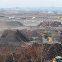 Scorched earth: Seen from Kaigan Park, cleanup and waste-separation efforts continue on the Arahama plain east of Sendai two and a half years after the tsunami triggered by the Great East Japan earthquake. | STEPHEN HESSE