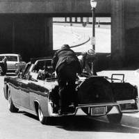 Moment of disbelief: Secret Service agent Clint Hill leaps aboard the rear deck of John F. Kennedy\'s limousine immediately after the president was fatally shot in Dallas on Nov. 22, 1963. | AP